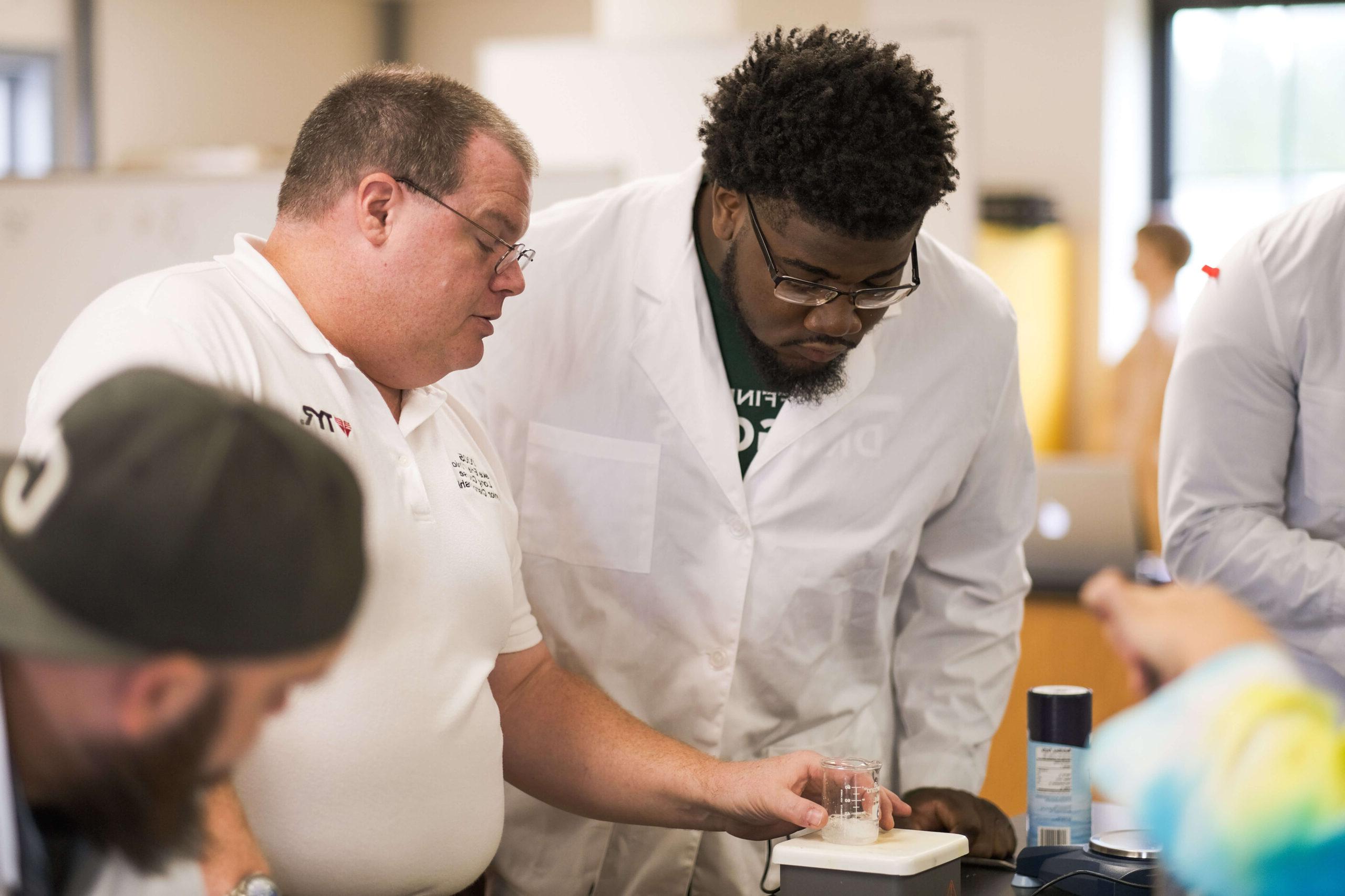 professor and student doing lab experiment